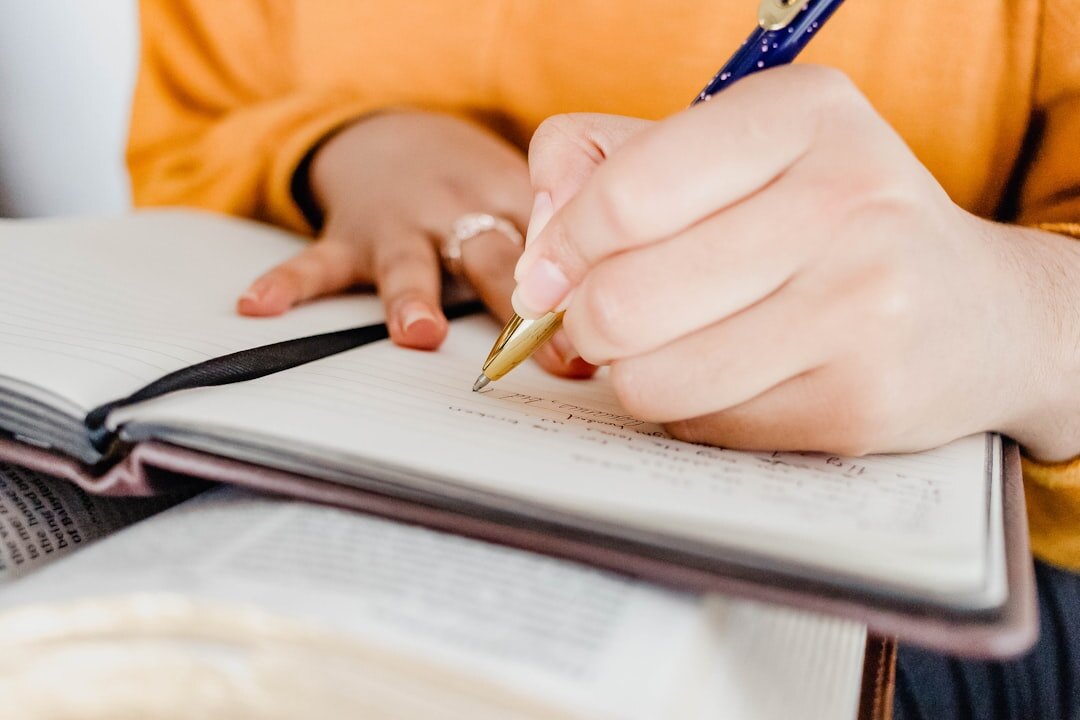 person writing in notebook