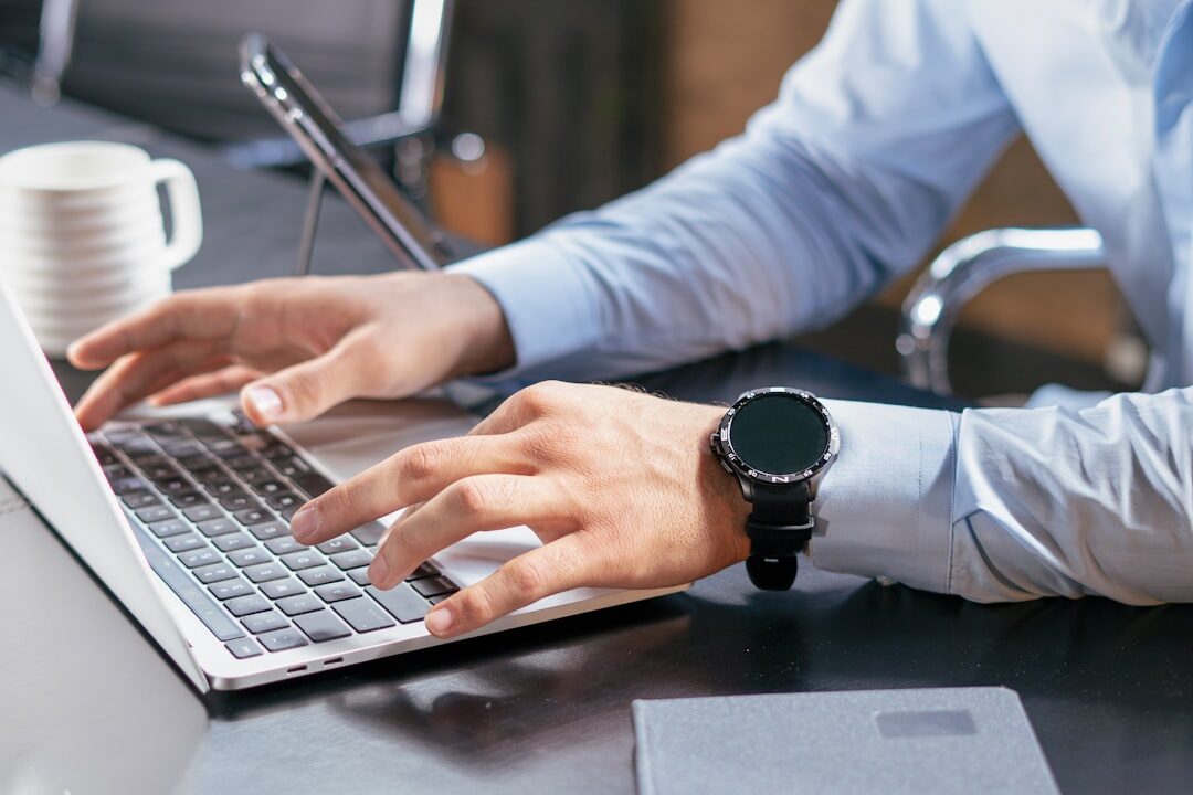 person writing on laptop