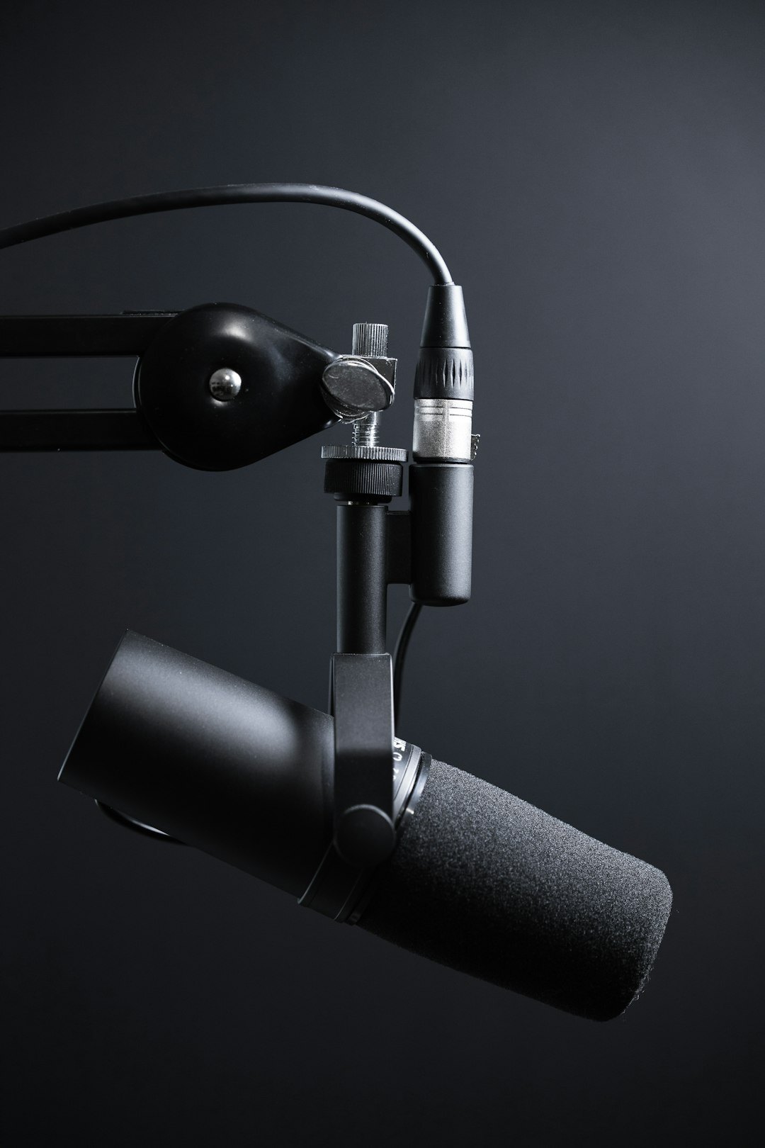 Modern podcast recording studio with professional microphones and warm lighting