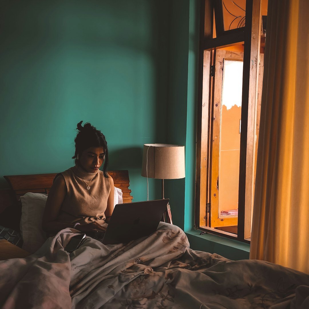 Portrait of a young Portuguese woman reading on a laptop